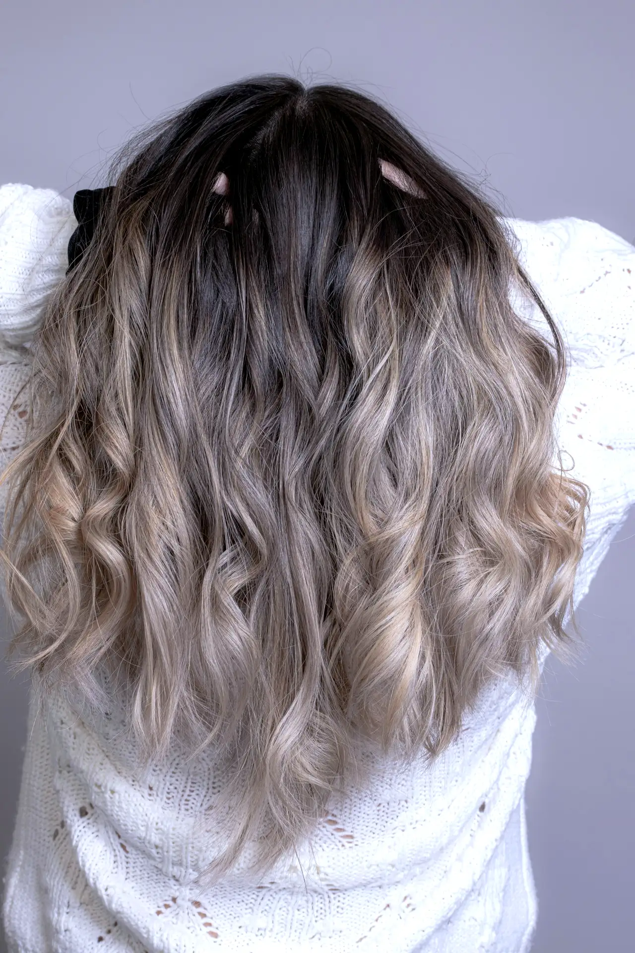 Long ash-blonde hair with a glossy finish, seen from behind