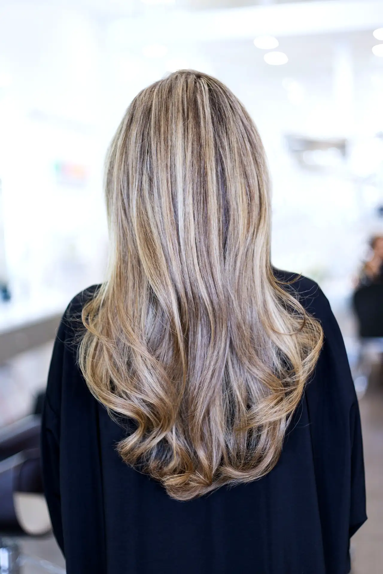 Honey-blonde hair from behind, shiny and layered